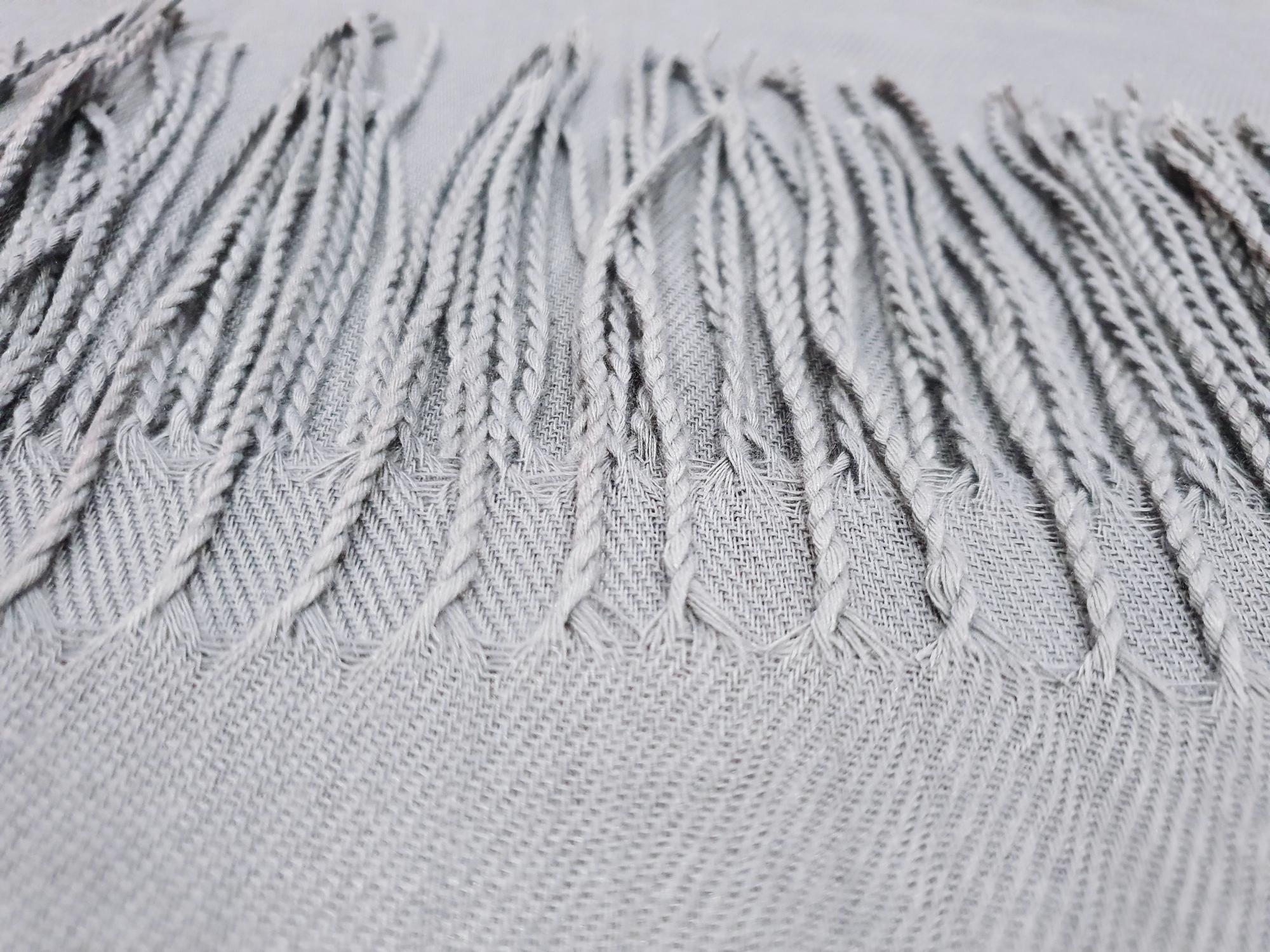 close-up of blue embroidery thread on fabric with digital pattern overlay